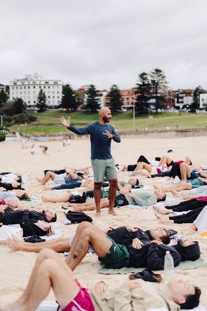 Navjot Matharu facilitating a group meditation session on Bondi Beach