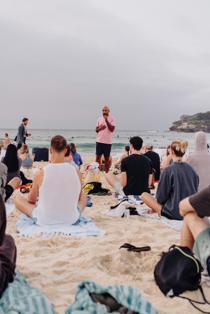 Navjot Matharu, personal development coach, standing and speaking during a facilitated session